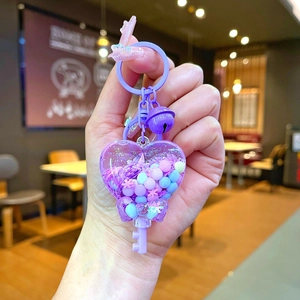 Handheld purple heart-shaped liquid quicksand keychain with bell and wand pendant charm