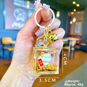Detail of Fortune Cat liquid keychain with gold bell and dimensions showing 4x3.5cm
