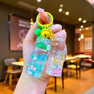 Luminous drift bottle keychain with liquid quicksand and floral beads for backpacks