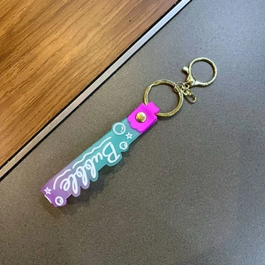Gradient glitter keychain with purple to teal silicone strap and Bubble lettering