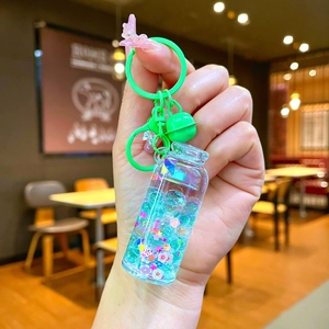 Glow-in-the-dark drifting bottle keychain with blue liquid and sequins for schoolbags