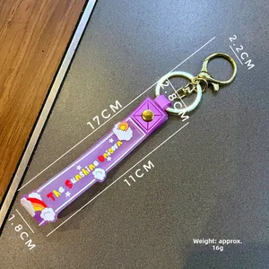 Detail of purple silicone lanyard keychain with Sunshine Unicorn text and rainbow graphics