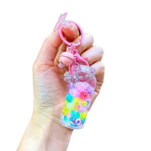 Creative drifting bottle keychain with luminous colorful beads and pink bell pendant