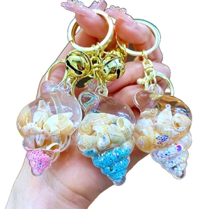 Acrylic ocean shell keychain with liquid quicksand, seashells and mini gold bell
