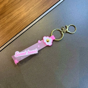 Pink translucent soft glue keychain with white 3D flowers and golden metal ring