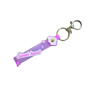 Cute purple PVC strap keychain with 3D flower and Sweet Heart text on white background