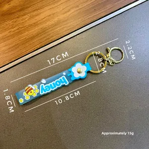 Detailed size specifications for blue silicone wristlet keychain with honey bee patterns