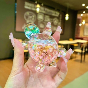 Cute cherry blossom turtle ornament with pink petal sequins and golden glitter