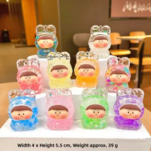 Detail showing various colors of acrylic liquid sand keychains with cute bunny hoods