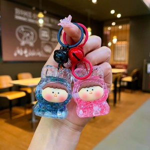Cute blue and pink glitter liquid acrylic keychains with cartoon doll charms and bells