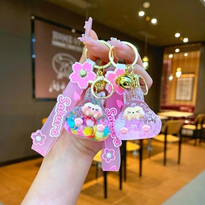 Pink acrylic bunny keychain with flowing liquid beads, cherry blossom charm and Sakura wrist strap