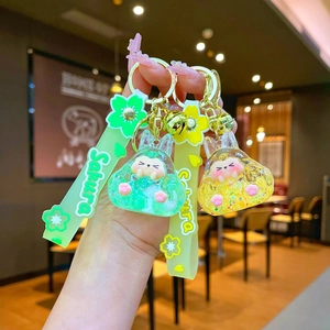 Cute acrylic cherry blossom rabbit liquid keychain with glitter and sakura strap charms