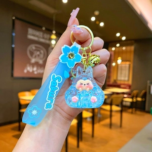 Macro shot of creative liquid quicksand rabbit keychain with Sakura silicone wristband