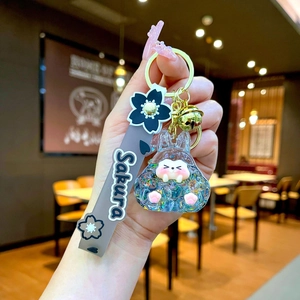 Close-up of a Sakura themed creative keychain with resin character and PVC wristlet