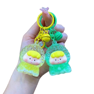 Cute cartoon character quicksand keychains in yellow and green with mini bells