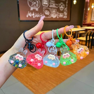 Set of five colorful resin bunny keychains with shiny glitter beads and matching bells