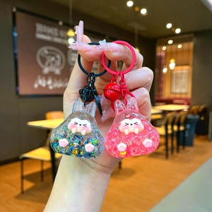 Close-up of translucent rabbit keychains with colorful sequins and small bells