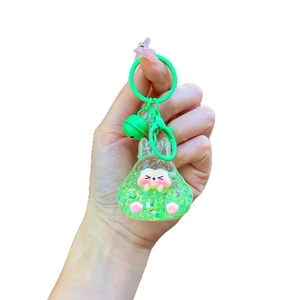 Luminous green glitter resin bunny keychain with a bell and metal lobster clasp