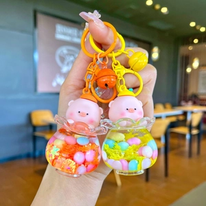 Cute pink pig liquid glitter keychains in clear jars with bells and colorful hooks