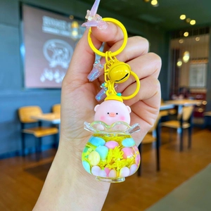Luminous floating liquid keychain featuring a cute pink pig and bright yellow metal keyring