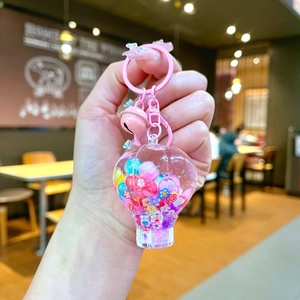 Macro shot of pink hot air balloon keychain with beads, sequins and small bell charm