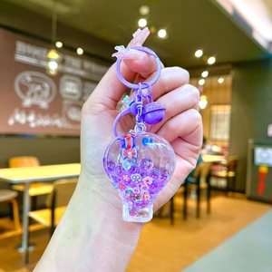 Handheld purple hot air balloon keychain with liquid quicksand and floral glitter inside