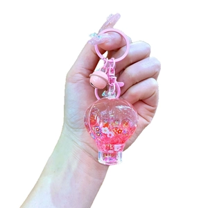 Pink hot air balloon liquid keychain with glowing bubble beads and small bells