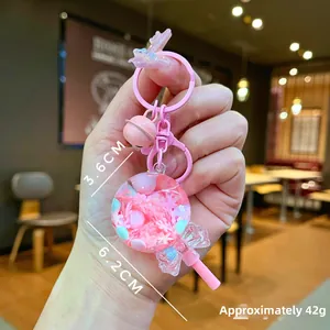 Porte-clés sucette en résine rose avec cloche et nœud, vue détaillée des dimensions 6,2cm