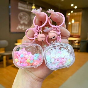 Macro detail of acrylic liquid quicksand keychain with pink bell and lobster clasp