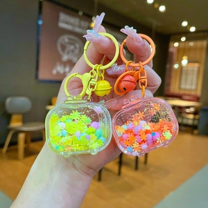 Detail of creative TV shaped keychain with colorful liquid sand and shiny star charms