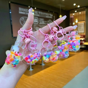 Close-up of cute rainbow bead floating keychains with heart and rabbit shapes
