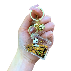 Acrylic panda liquid sand keychain with golden stars and bell in a handbag shape