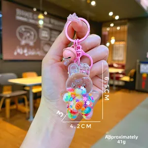 Detail of bunny oil-filled keychain with stars and size specs at 6.5x4.2cm