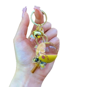 Creative bubble tea keychain featuring a floating bear in liquid yellow sand bottle