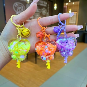 Three creative heart-shaped liquid quicksand keychains with colorful beads and small bells