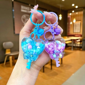 Set of heart-shaped luminous snowflake liquid quicksand keychains in blue and purple