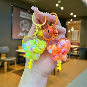 Luminous heart-shaped liquid quicksand keychain with snowflakes and colorful beads