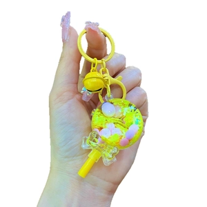 Porte-clés sucette jaune avec shaker liquide, perles colorées et breloque noeud