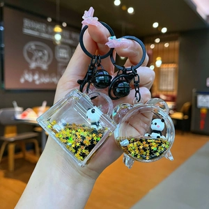 Cartoon panda liquid quicksand keychain with black gold metal clip and acrylic star sequins
