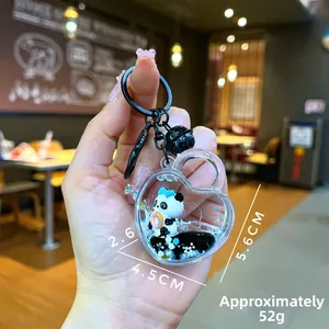Porte-clés cœur panda avec liquide mobile noir et panda tenant un donut en gros plan