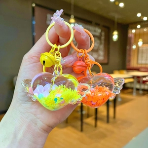 Cute winged heart-shaped liquid keychains in bright yellow and orange with colorful bells