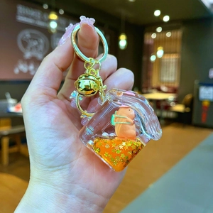 Porte-clés Capybara en acrylique avec sable mouvant orange et paillettes étoilées