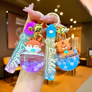 Cute cartoon penguin and deer liquid eggshell keychains with colorful charms and bell