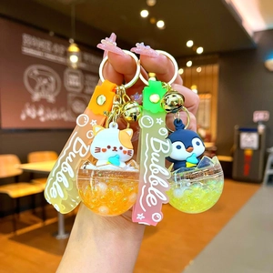 Cartoon penguin and cat liquid oil keychains with colorful bubble tea cup charms
