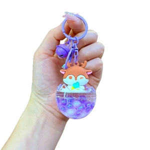Cartoon orange deer keychain with liquid sand base and purple bell hanging ornament