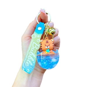Cartoon tiger liquid oil keychain with blue floating charm and gold bell accessory
