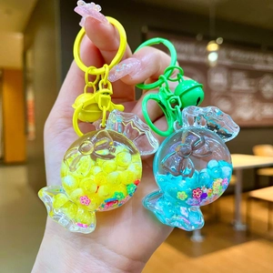 Luminous macaron candy keychains with colorful beads and bells in yellow and blue