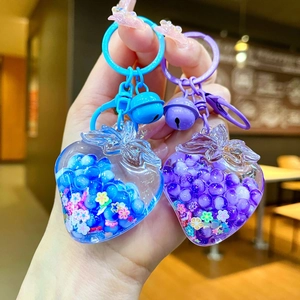 Glow-in-the-dark strawberry liquid oil keychain with colorful beads and bell charm