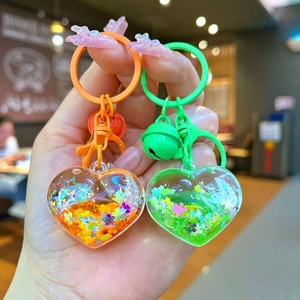 Cartoon heart shaped liquid sand keychains with colorful sequins and small bells