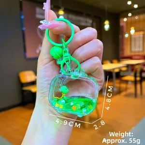 Macro shot of a turtle liquid sand keychain with green glitter and small bell
